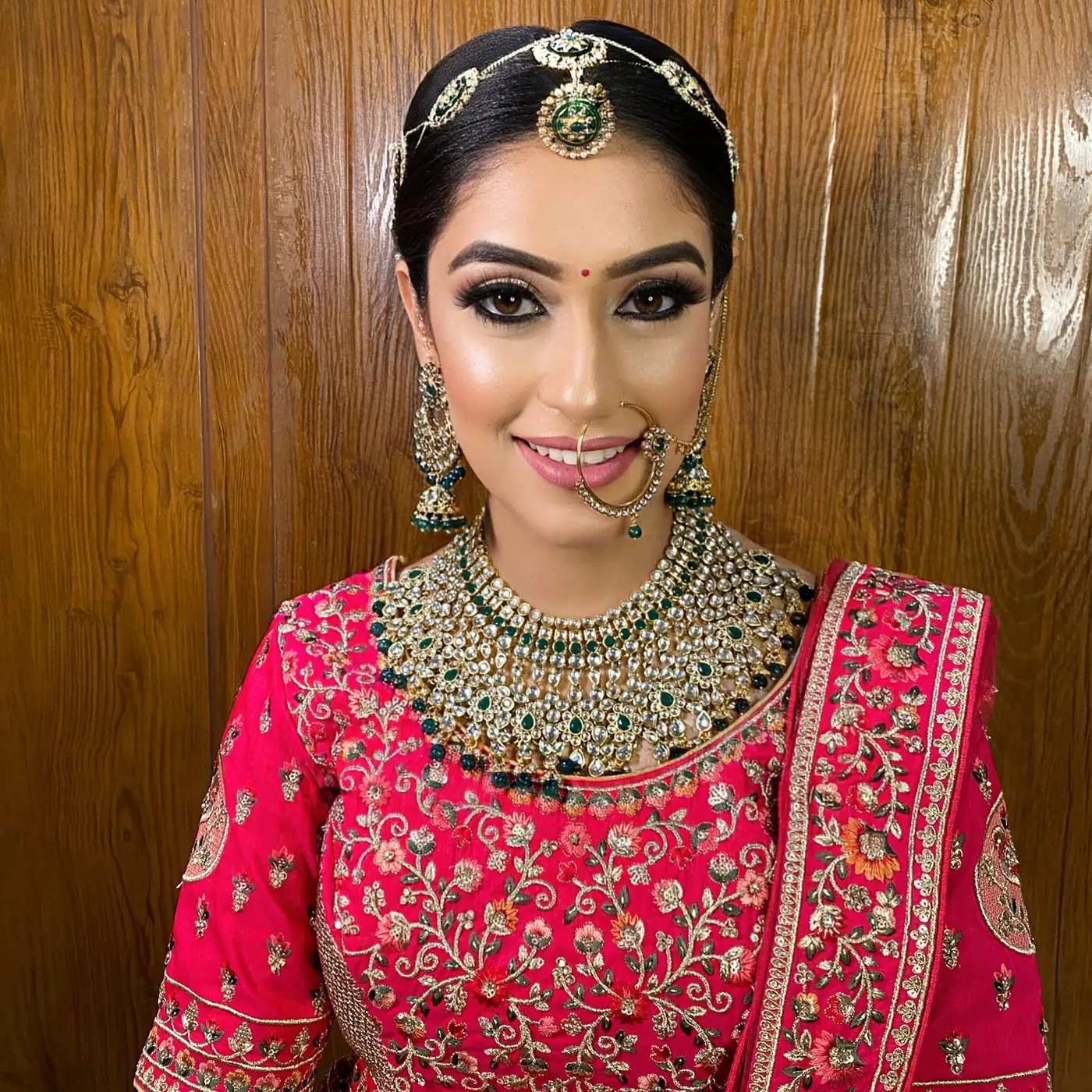 Rani Pink Lehenga, Smiling. Bridal makeup by Madhu Gupta at MG Makeovers, Gurugram